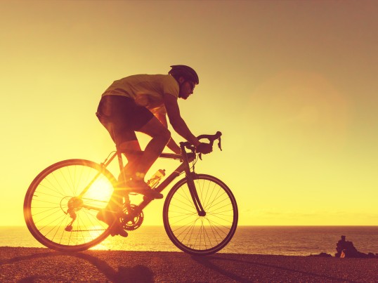 Cyclist-infront-of-a-yellow-backgroud